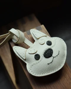 Dog Bag Charm handcrafted from French goatskin leather, hand-stitched over three days and gift boxed for bags, keys, and car key accessories.