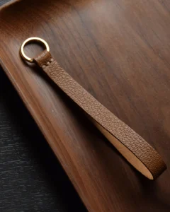 Keychain accessory components set featuring brass hardware, leather tassels, cords, and connectors for bag charms, keychains, and car key accessories.