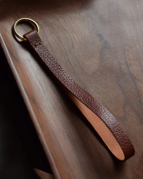 Keychain accessory components set featuring brass hardware, leather tassels, cords, and connectors for bag charms, keychains, and car key accessories.